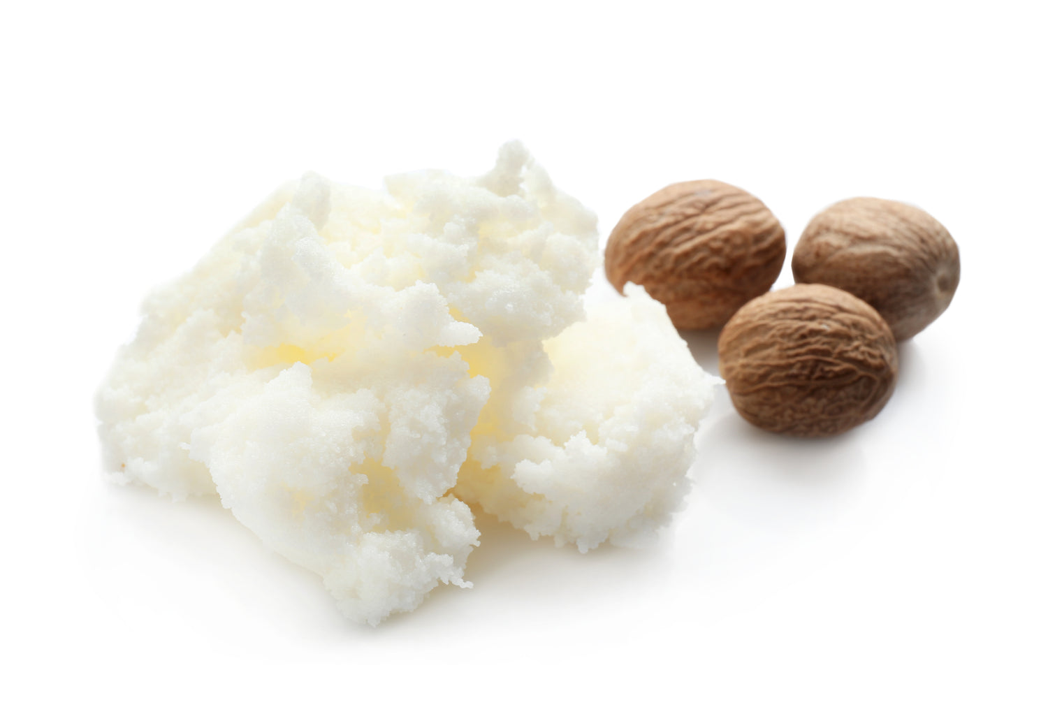 Shea butter with three shea nuts in the background