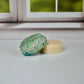 Detox shampoo bar and conditioner bars sitting on a white table with a window in the background