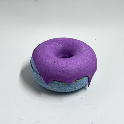 Blue Donut bath bomb with purple cocoa butter frosting. this bath bomb smells like ocean breeze