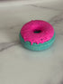 Donut bath bomb that is green with pink frosting