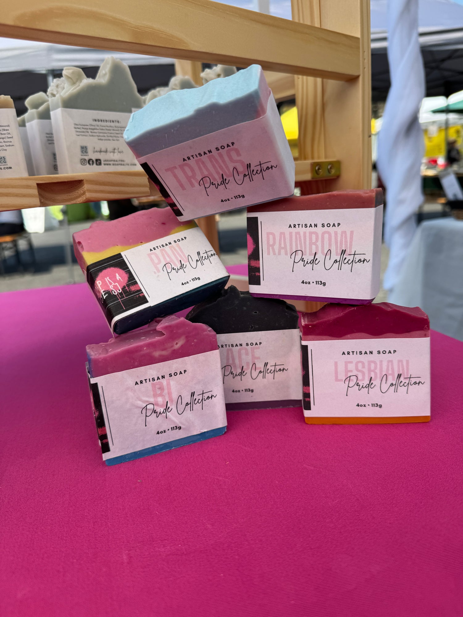 Bars of soap with pink packaging on a pink surface