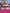 Packaged products on a pink surface with a blurred outdoor background