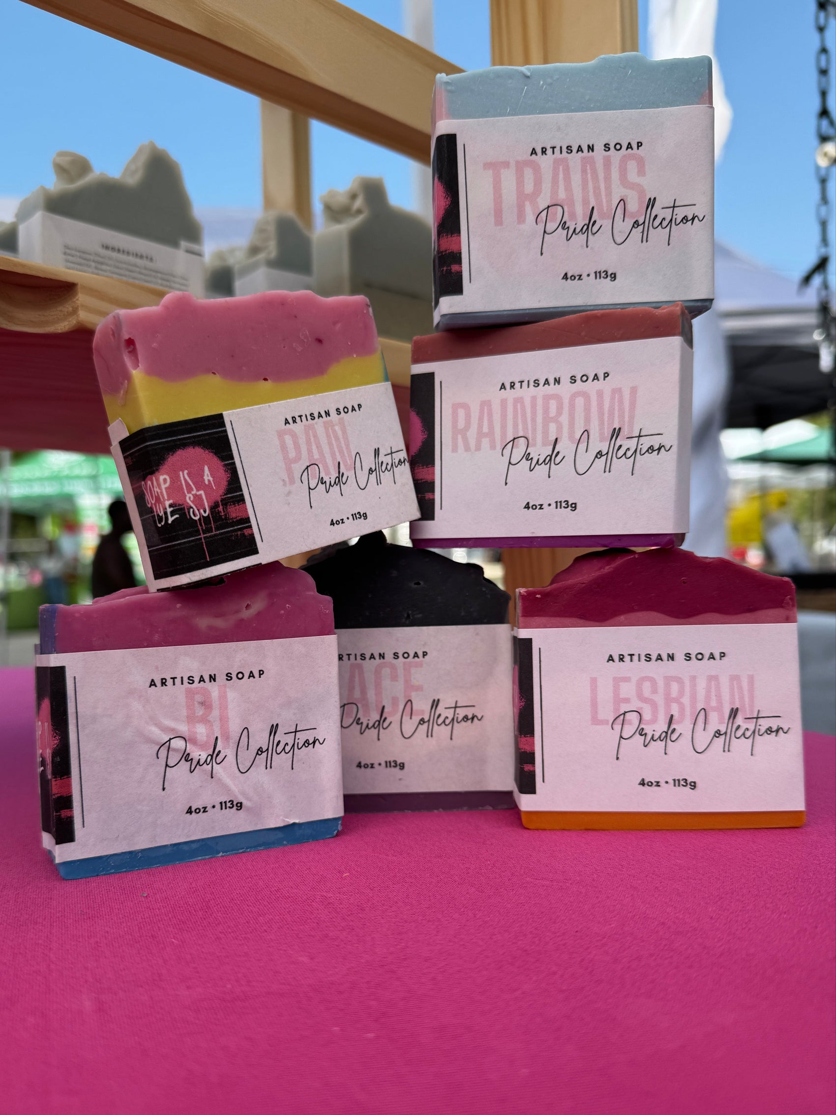 Packaged products on a pink surface with a blurred outdoor background