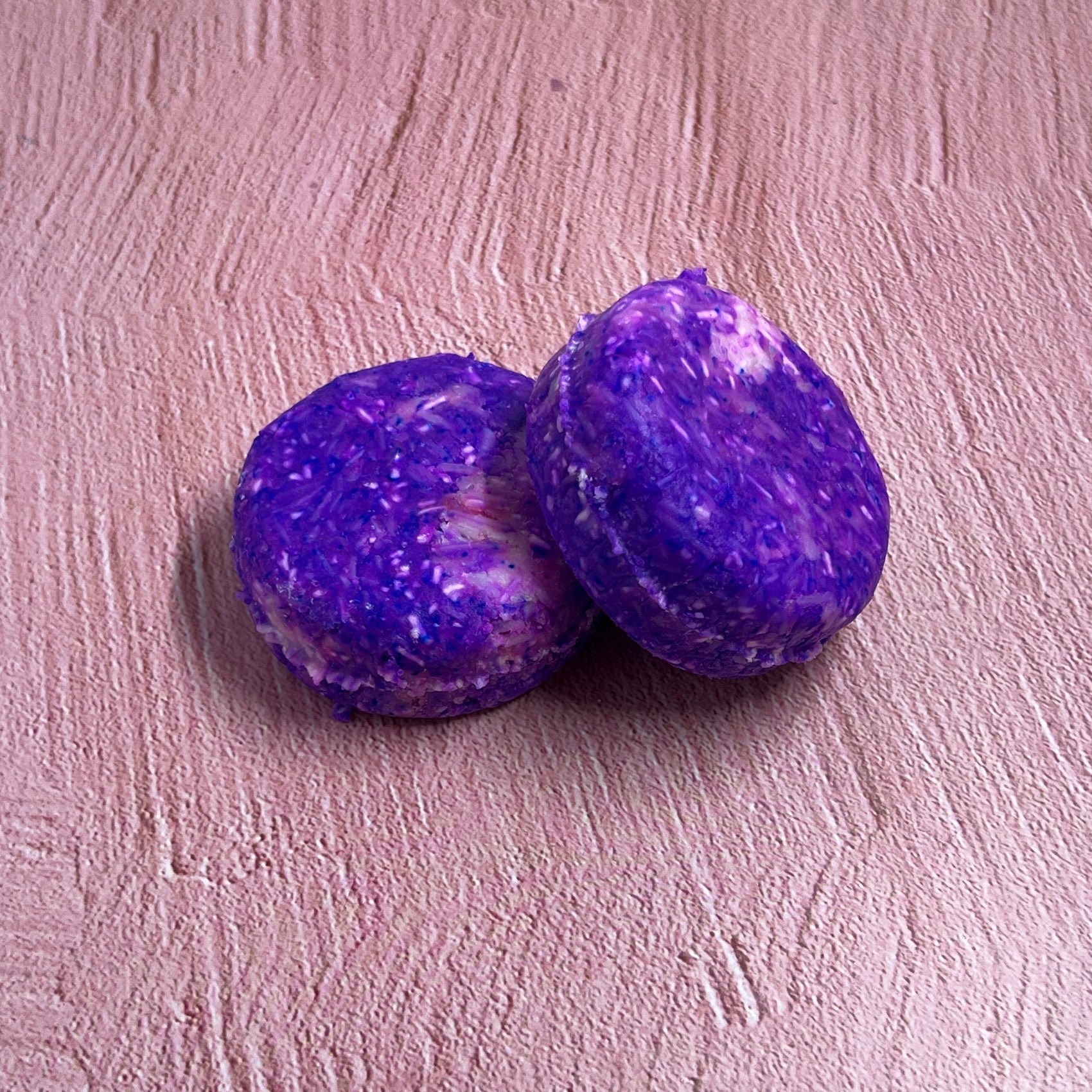 Shampoo bars on a pink background
