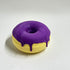 yellow donut bath bomb with purple frosting